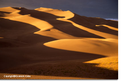 A line of light lights up the dunes.